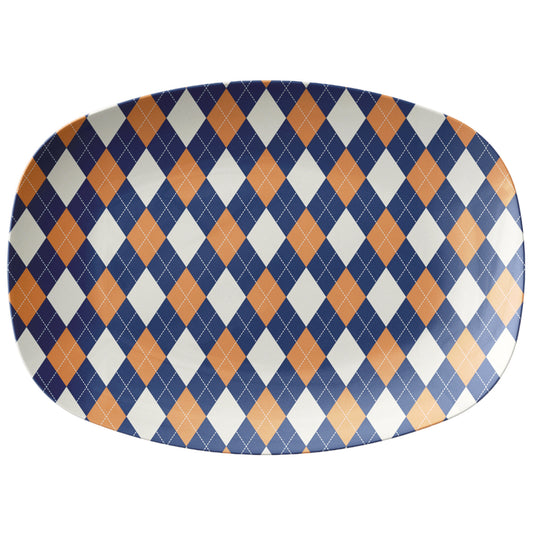 Oval serving platter with an argyle diamond pattern in navy blue, orange and cream.