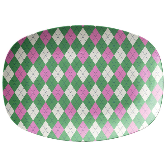 Oval serving platter with an argyle diamond motif pattern in pink, green and cream.