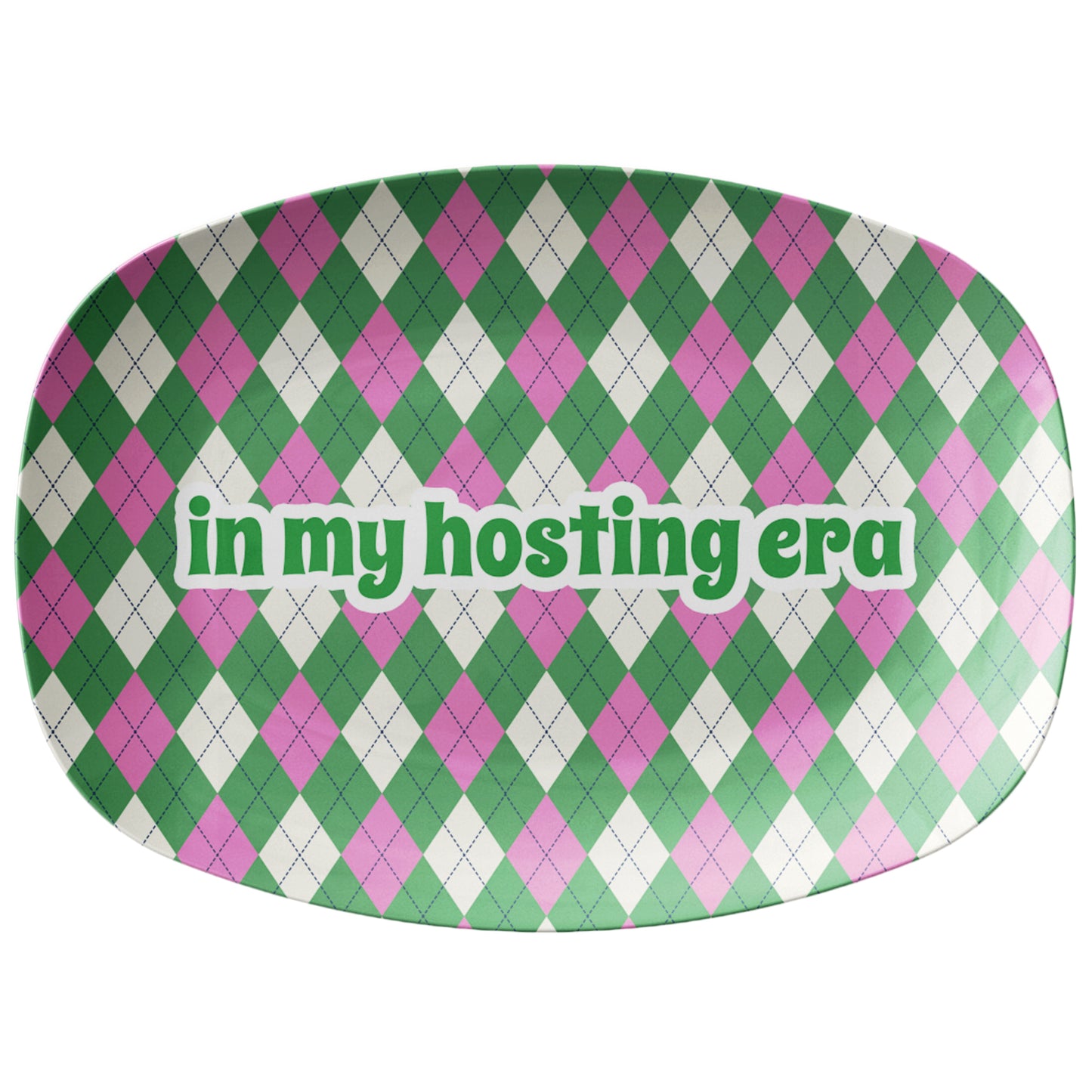 Green and pink argyle pattern printed on a serving platter with text that says in my hosting era.