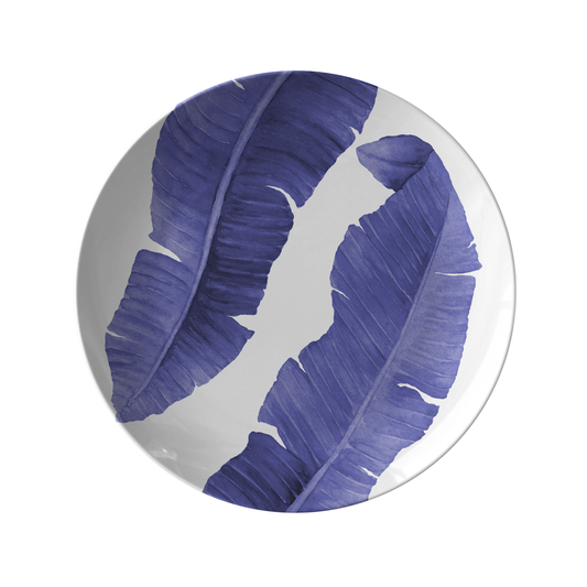 Melamine like plastic dinner plate with navy blue and white banana leaf print.