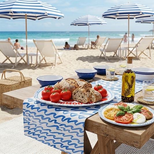 Beachside table with food and drinks under striped umbrellas with a beach background