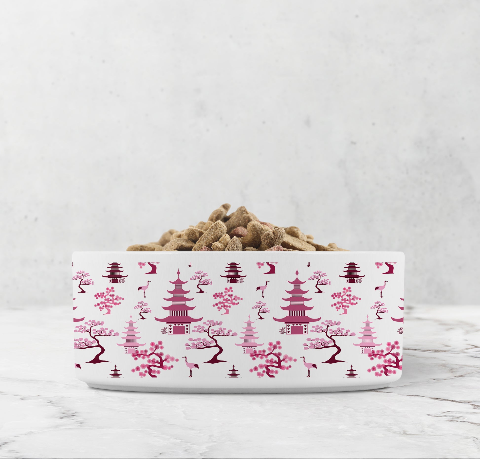 Pink chinoiserie dog food or cat water bowl features hand drawn bonsai trees, pagodas and crane birds.