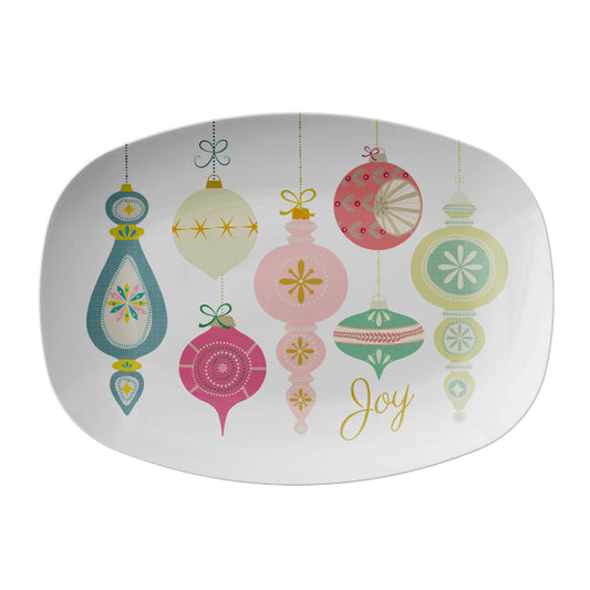 Decorative plate with colorful vintage Christmas ornaments and the word 'Joy' on a white background