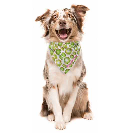 Dog wearing a bandana with a green jewel pattern and custom name on a white background
