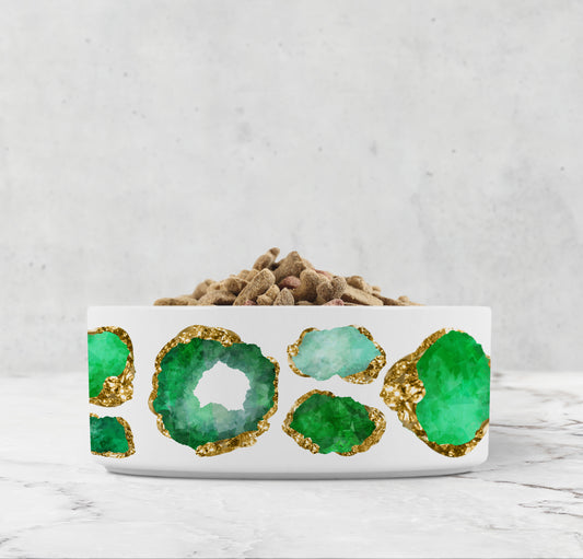 White ceramic pet bowl with emerald green and gold jeweled print.