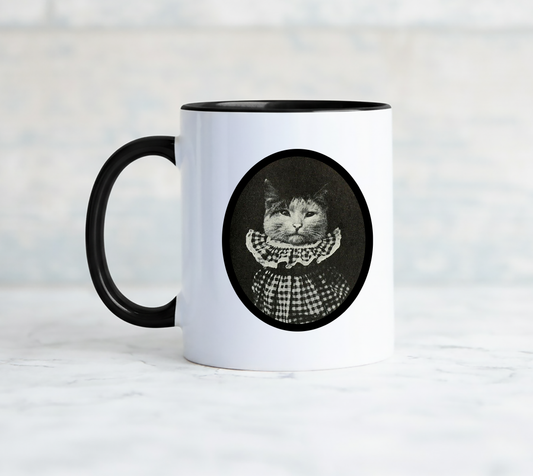 White mug with a black handle features a vintage cat in a gingham ruffled collar and says i am pretending to tolerate you.