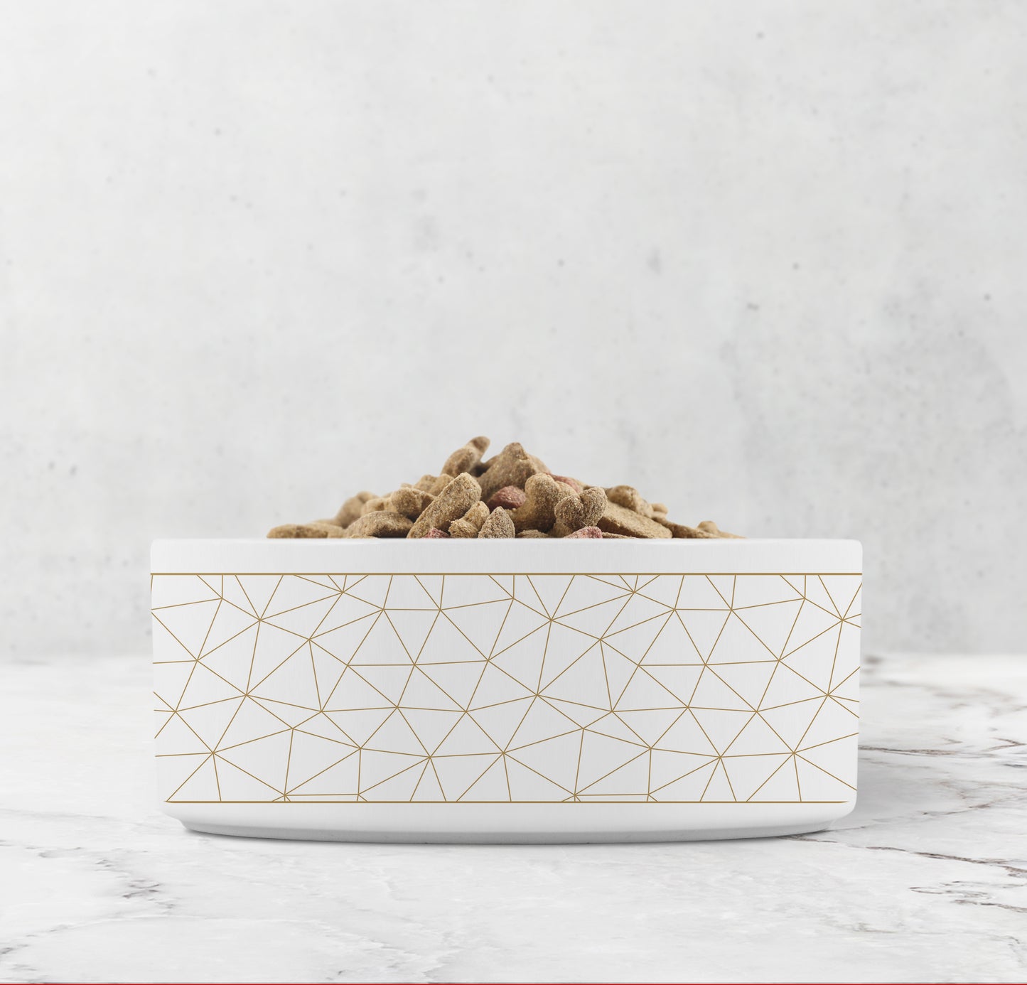 Gold and white dog bowl with geometric lines.