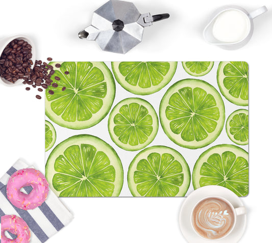 Lime kitchen counter mat has colorful sliced limes printed on moisture wicking polyester mat with nonskid rubber back.