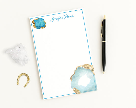 Aquamarine gemstones printed on white notepad personalized with any name.