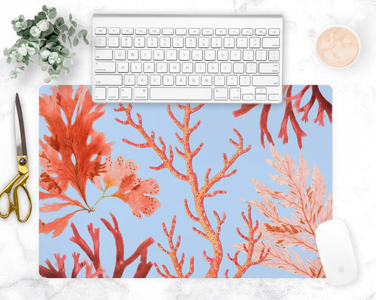 Ocean coral desk mat features red, orange and pink sea coral printed on sky blue mat. May also be used as a counter trivet or bar mat.