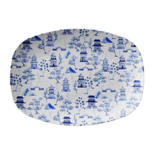 Blue and white asian pagodas, trees, bridges and mountains are printed on this white chinoiserie toile serving platter.