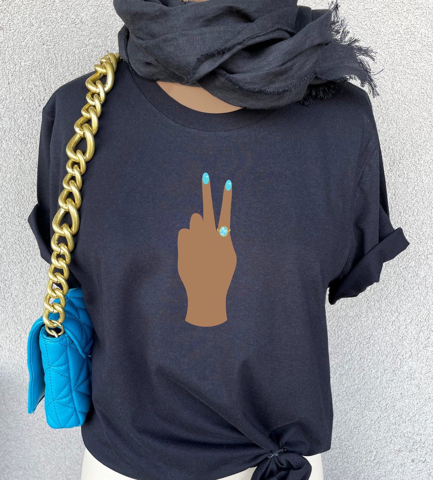 Peace Sign print t-shirt for women. Classic crewneck short sleeve tee features a hand wearing a glamorous aqua ring and a fabulous light blue manicure showing the peace sign. Fantastic gift for her.