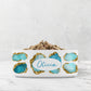 Customized blue and white pet bowl with aqua and gold jewel print personalized with your pet's name