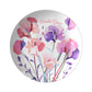 Round personalized plate with sweet pea floral design and custom name on a white background