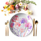 Floral-patterned sweet pea flower print plate with cutlery and flowers on a white background