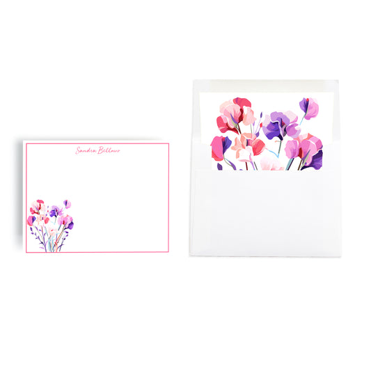 Notecard stationery set personalized with custom name features sweet pea flowers on bordered notecard and hand lined envelope. 