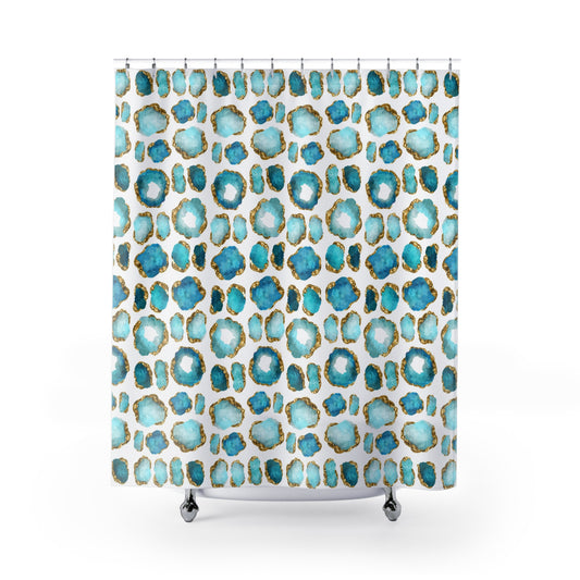 Shower curtain with aquamarine and gold crystal gemstones printed all over a white background.