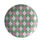 Round dinner plate with pink, green and cream argyle diamond pattern.
