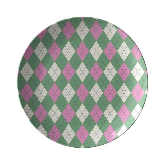 Round dinner plate with pink, green and cream argyle diamond pattern.
