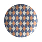 Dinner plate in an argyle diamond pattern in orange, navy and cream.