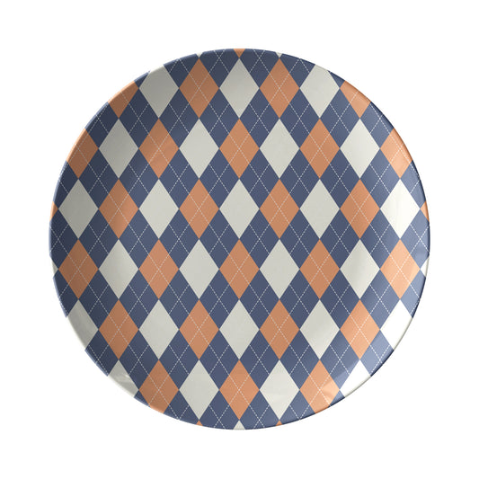 Dinner plate in an argyle diamond pattern in orange, navy and cream.