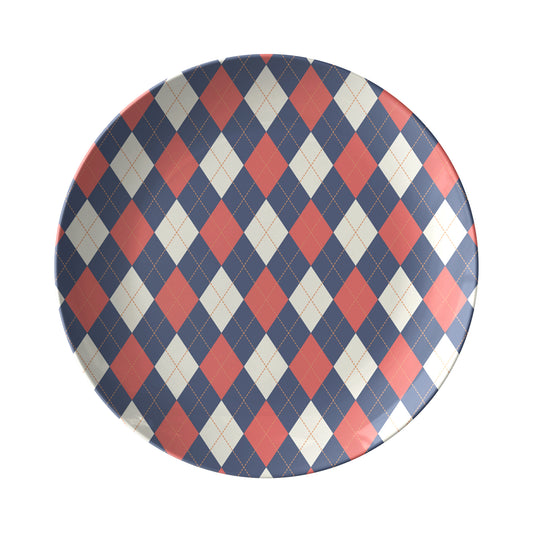 Round plate with a navy, red and cream diamond argyle pattern.