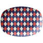 Oval serving platter with a diamond argyle pattern in navy, red and cream.