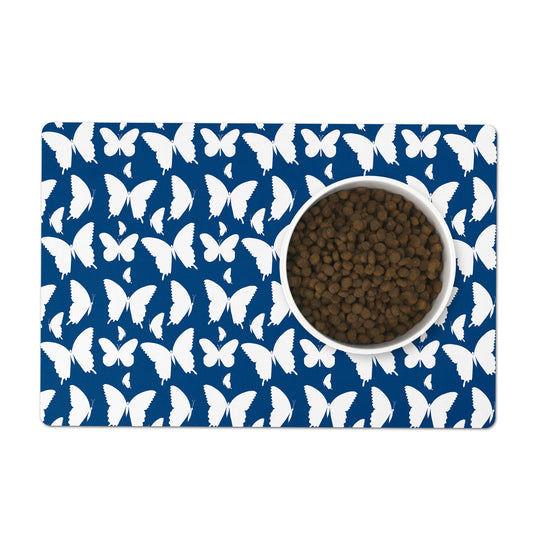 Hand drawn white butterflies on an indigo blue background pet feeding mat.