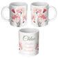 Three different sides  of a white  mugs with floral designs and custom text on a white background