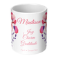 White mug with floral designs and text on a white background