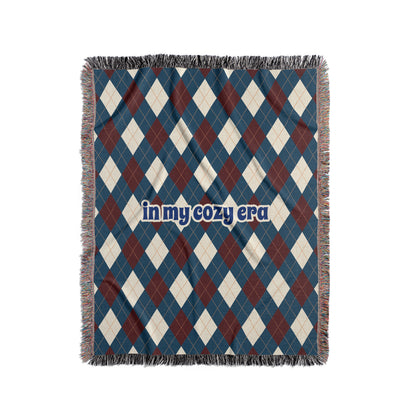 Argyle blanket that says In My Cozy Era, blue, red and cream.