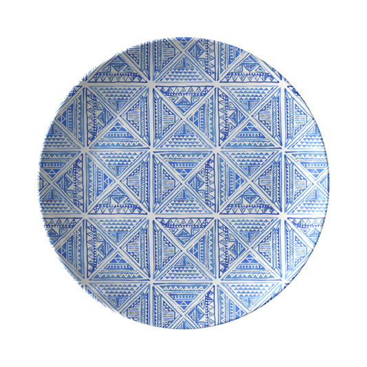 Round blue and white geometric tile patterned dinner plate on a white background
