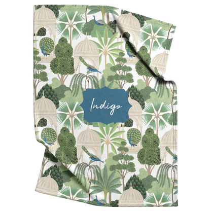 Pet blanket with tropical trees and peacocks with personalized text in the center.