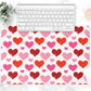 All over hearts pattern is printed on a white desk pad or counter mat.
