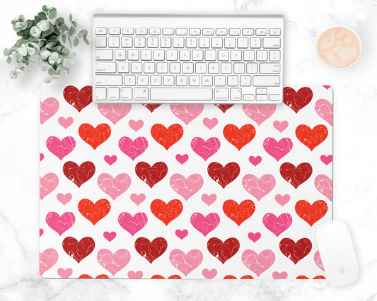 All over hearts pattern is printed on a white desk pad or counter mat.