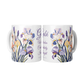 Two mugs with floral design and text on a white background
