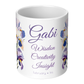 White mug with floral designs and custom name and text on a white background