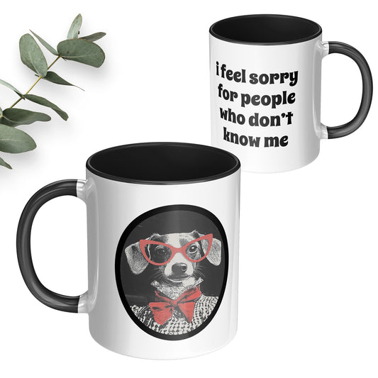 White ceramic coffee mug with a black handle and interior has an image of a funny dog with red glasses and on the back side says I feel sorry for people who don't know me.