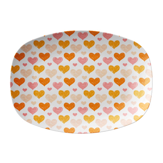 Oval-shaped platter with a pink and orange heart pattern on a white background