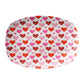 Oval-shaped serving platter with a pattern of red and pink hearts on a white background