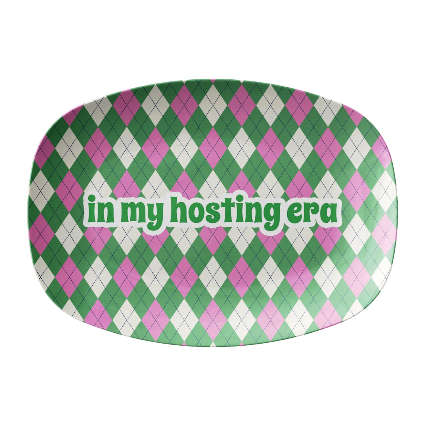 Green and pink argyle pattern printed on a serving platter with text that says in my hosting era.