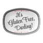 White serving dish has black and white label reading 'It's Gluten Free, Darling!' with a striped border on a white background.