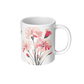 White coffee mug with carnation floral design on a white background