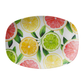 Oval serving platter with a fruit print - lemons, limes, oranges, pink grapefruit slices on white background.
