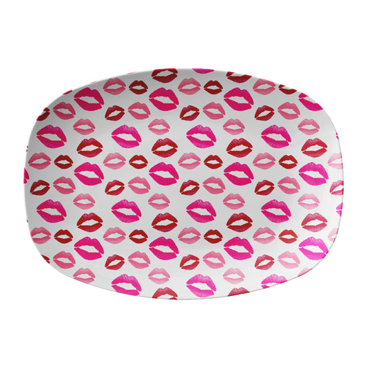 Oval serving platter has red, pink and coral lipstick kisses printed all over it.