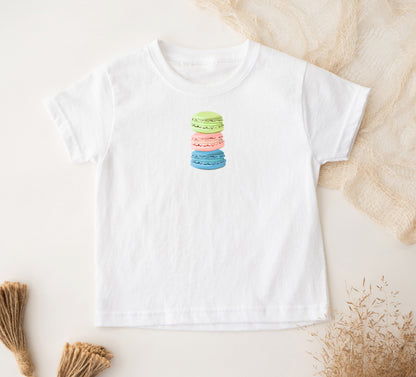 A white toddler t-shirt with a stacked macaron cookies design on the front.