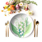 Lily of the Valley floral print plate dining table setting with cutlery and flowers.