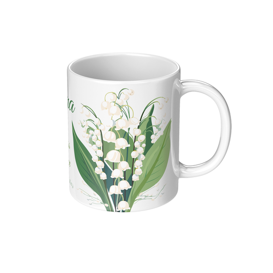 White ceramic mug with lily of the valley floral design on a white background