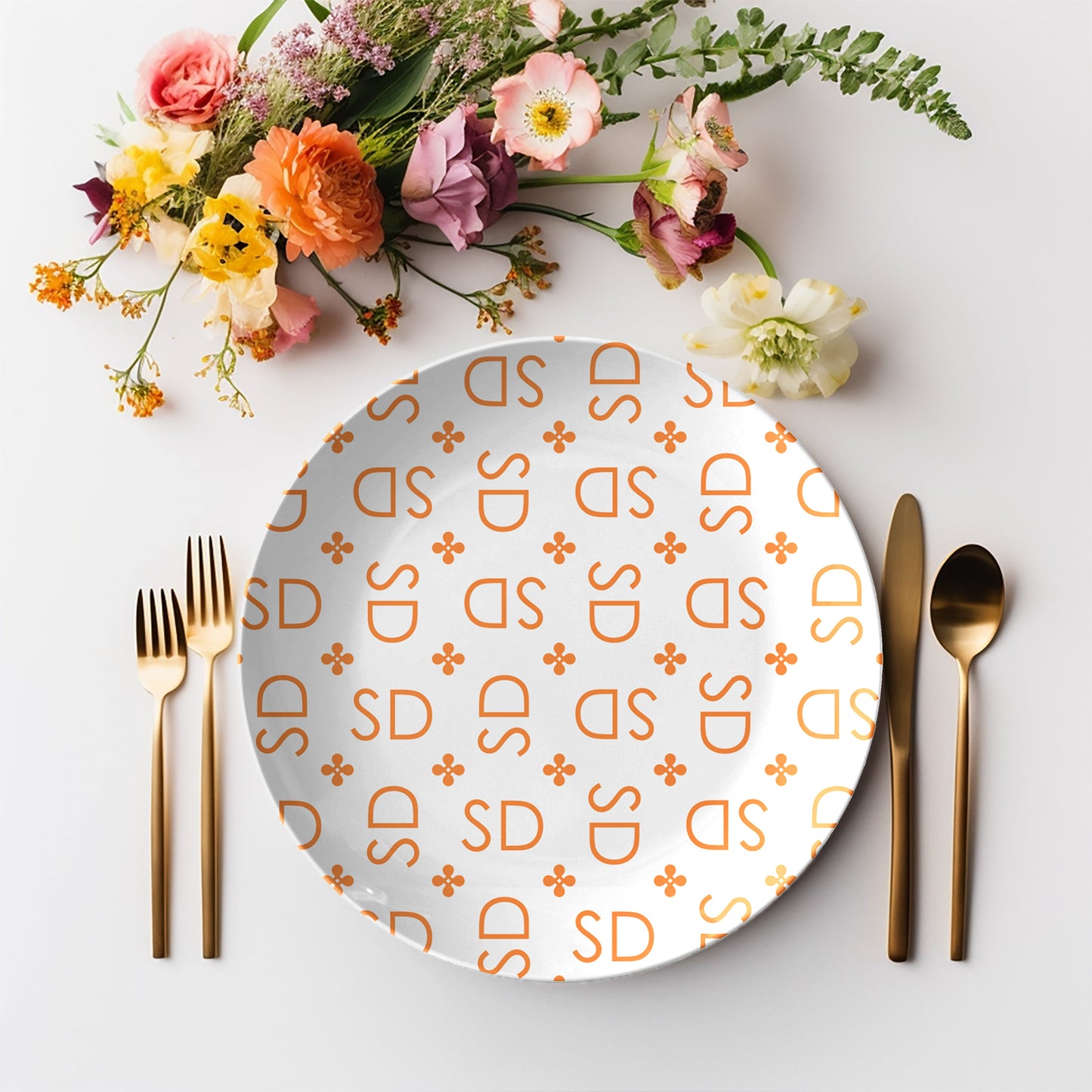 Personalized White and Orange Stylized Monogram Plate Set features customized initials set in a repeating pattern accented with a stylish motif for an all-over, modern design.