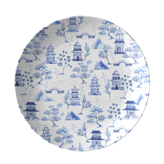 Blue chinoiserie toile pattern of pagodas and trees printed on white plate